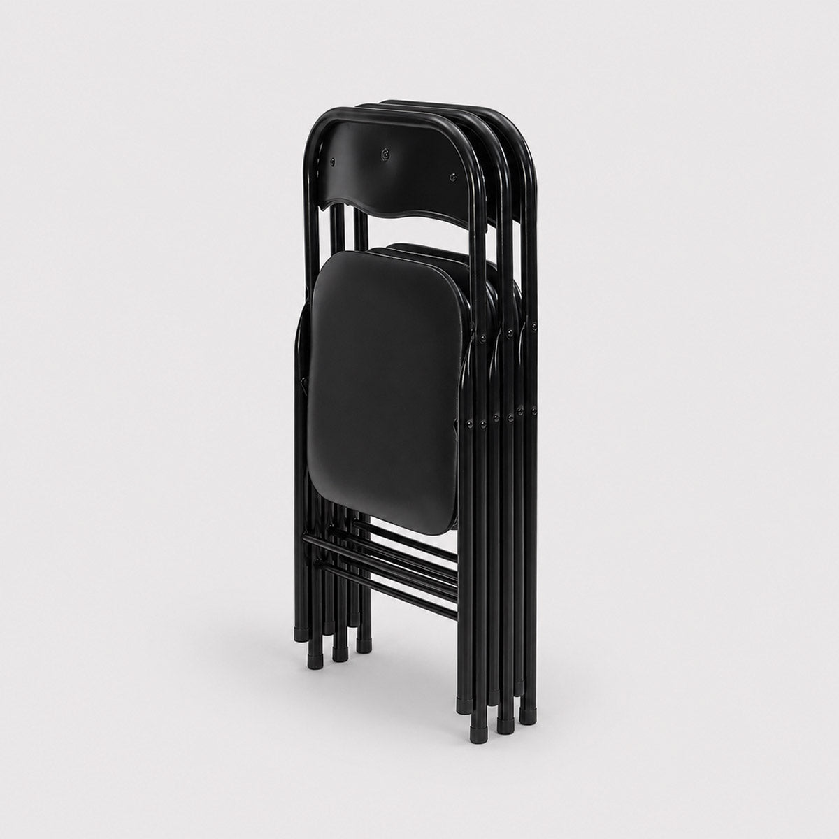 Stack of black folding outdoor seating hire on a light gray background