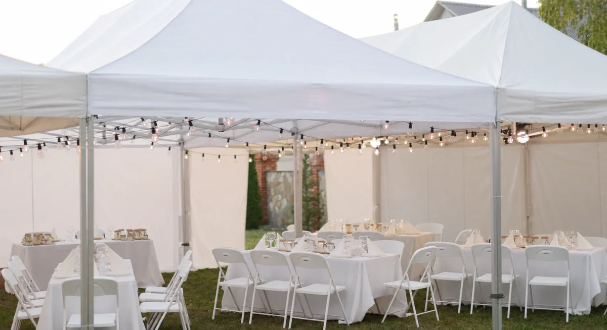 White marquee hire set up for an outdoor celebration